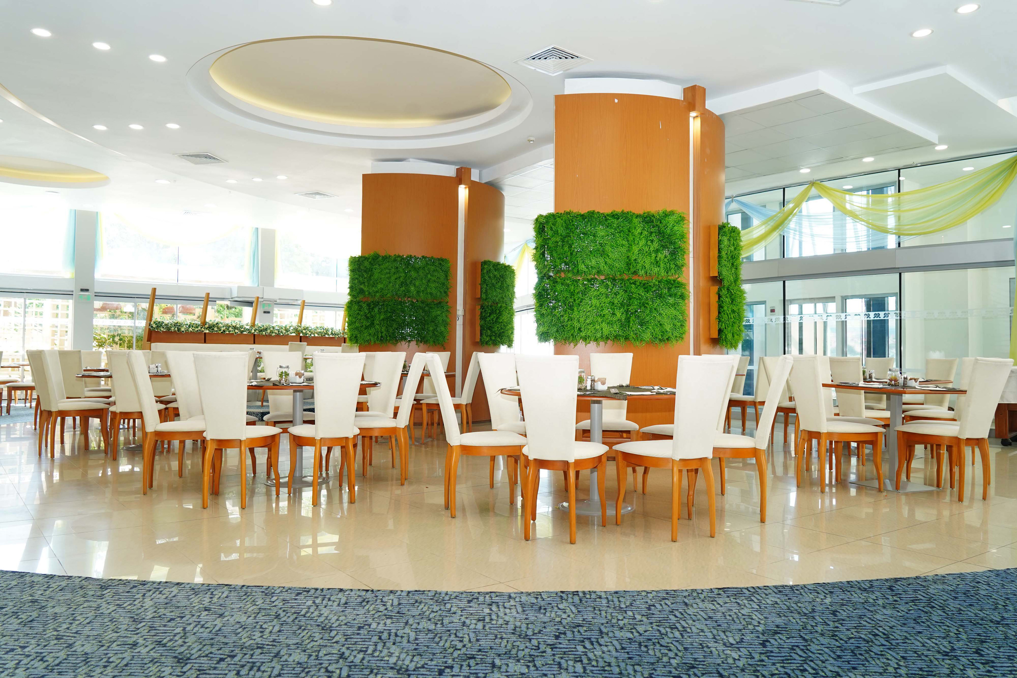 a room with white chairs and tables