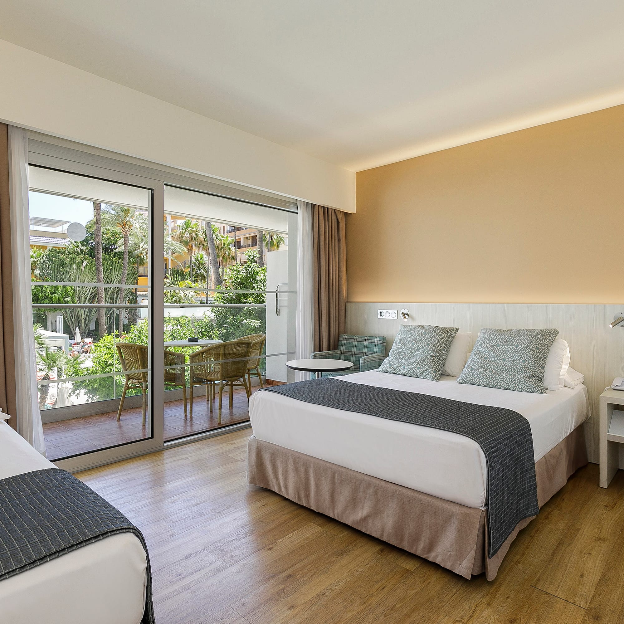 a room with two beds and a glass door