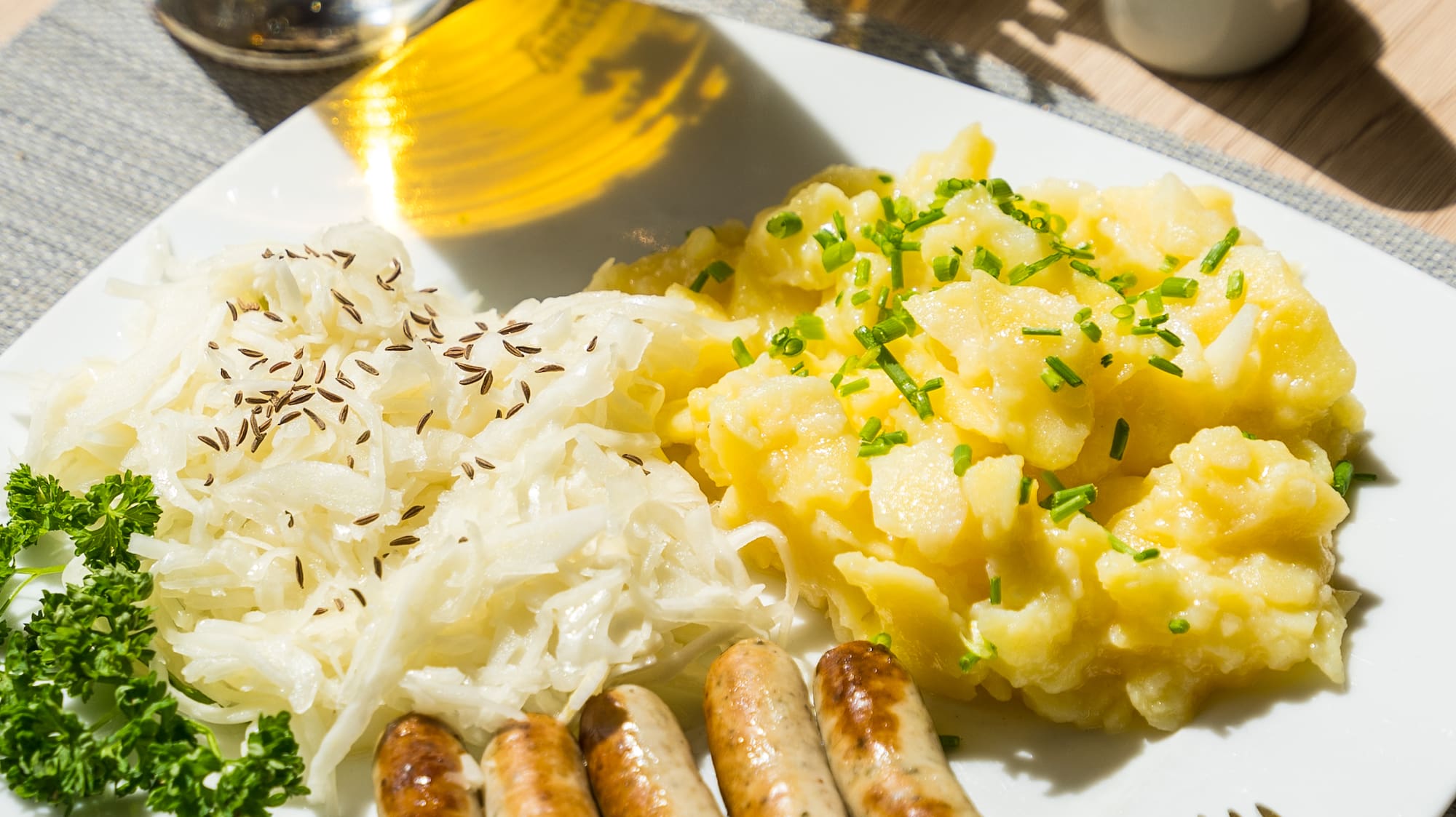 a plate of food with a fork and a glass of beer