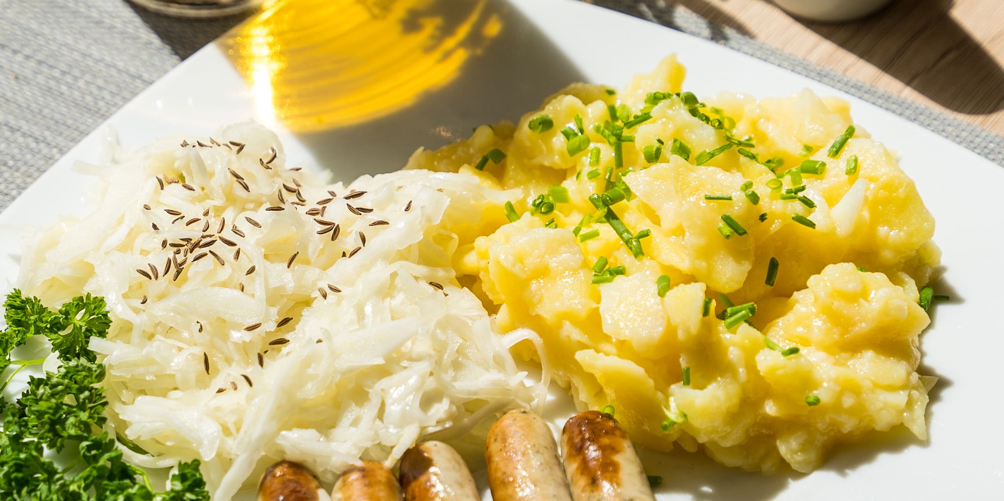 a plate of food with a fork and a glass of beer