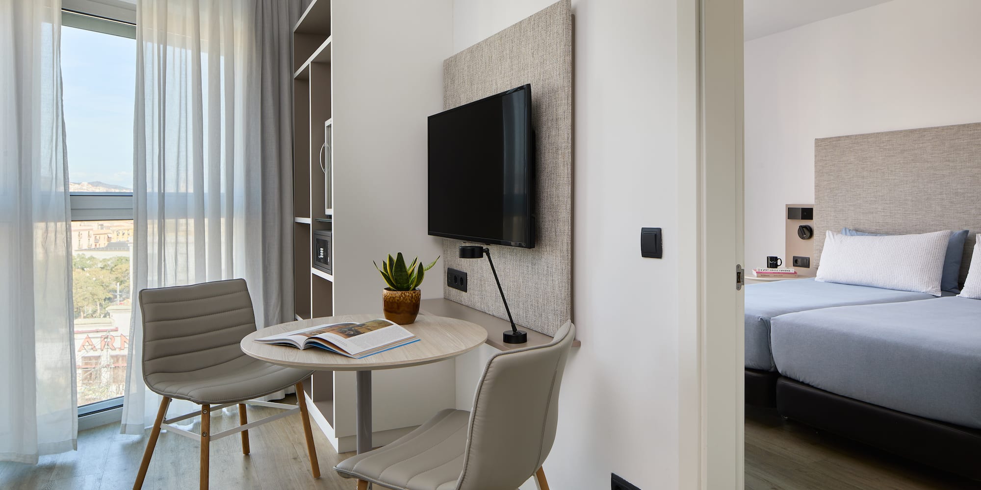 a room with a table and chairs and a tv