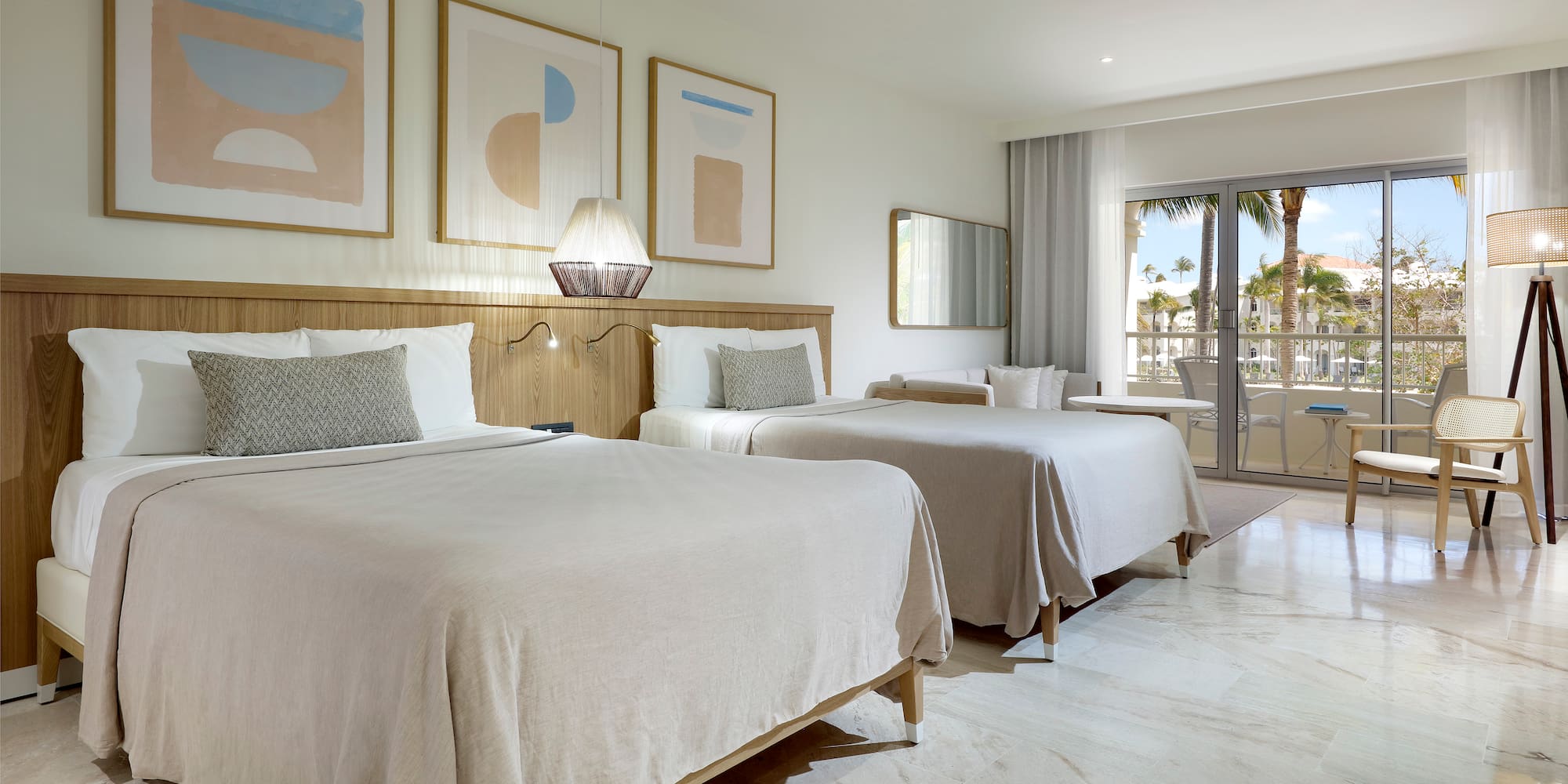 a room with two beds and a glass door