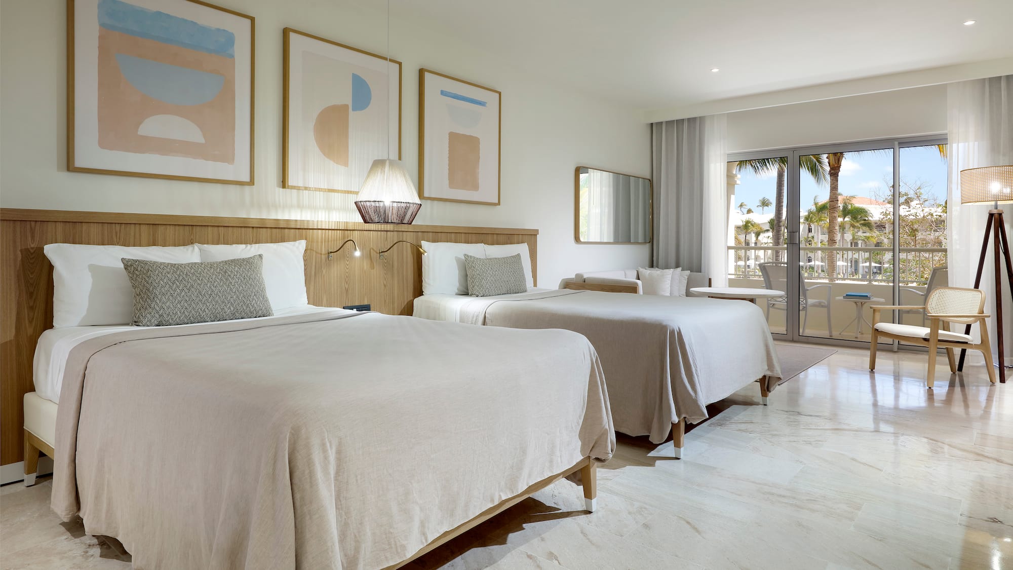 a room with two beds and a glass door