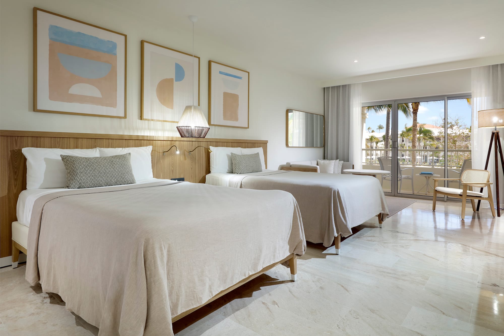 a room with two beds and a glass door