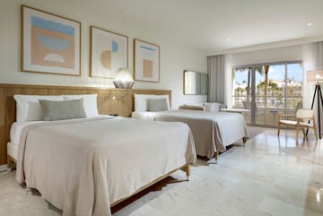 a room with two beds and a glass door