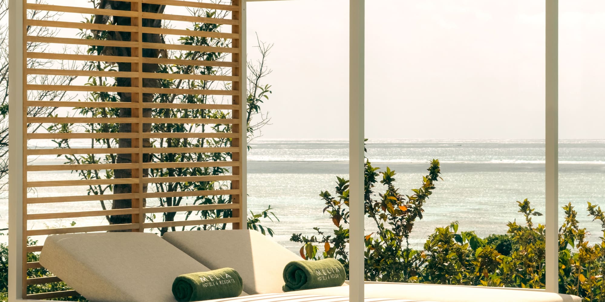 a lounge chair with a canopy on a patio overlooking the ocean