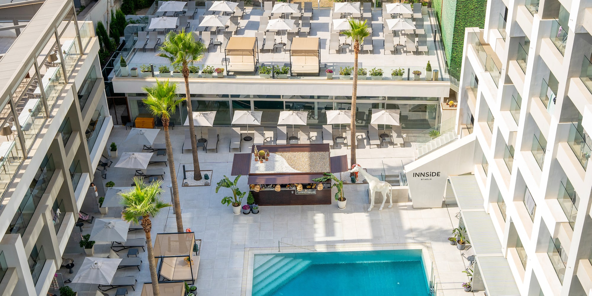 a swimming pool and a building with palm trees