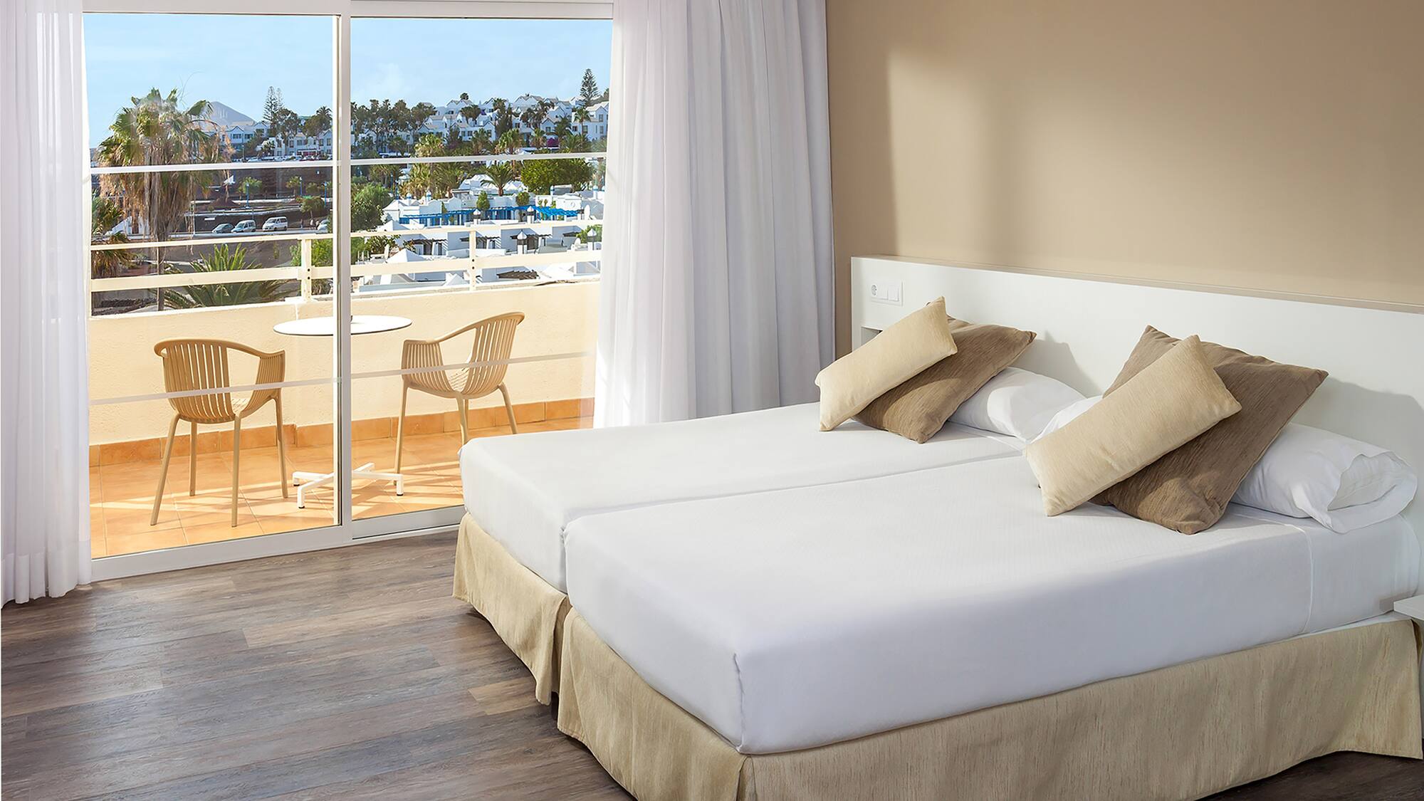 a hotel room with a view of the ocean and a balcony