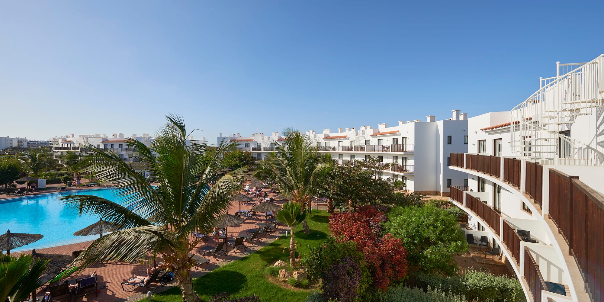 a resort with a pool and palm trees