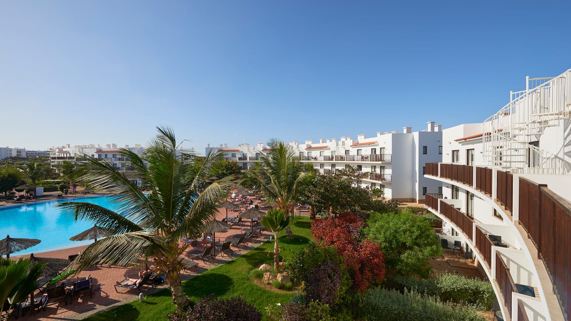 a resort with a pool and palm trees