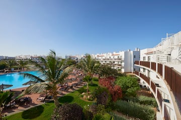 a resort with a pool and palm trees