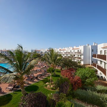 a resort with a pool and palm trees