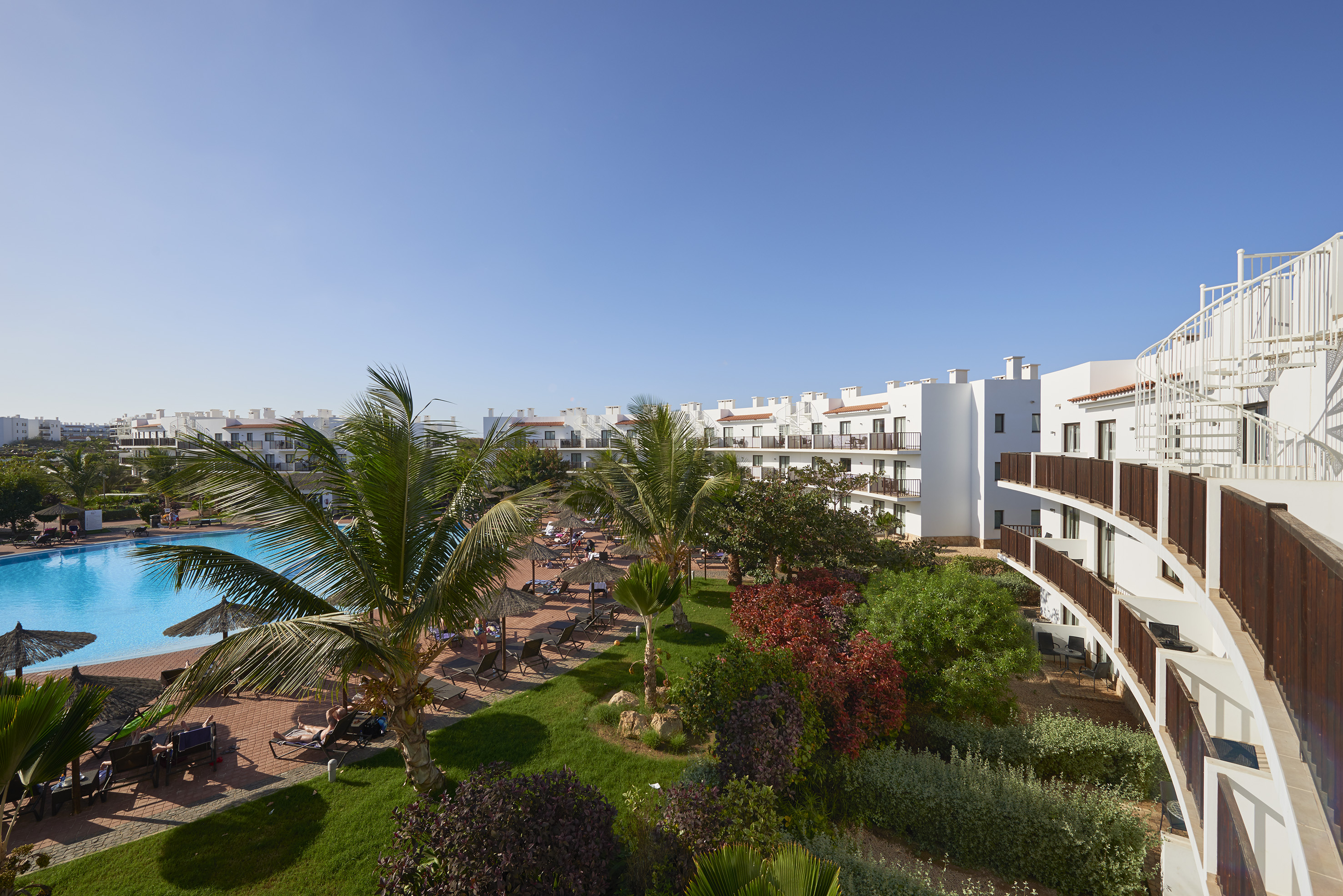 a resort with a pool and palm trees