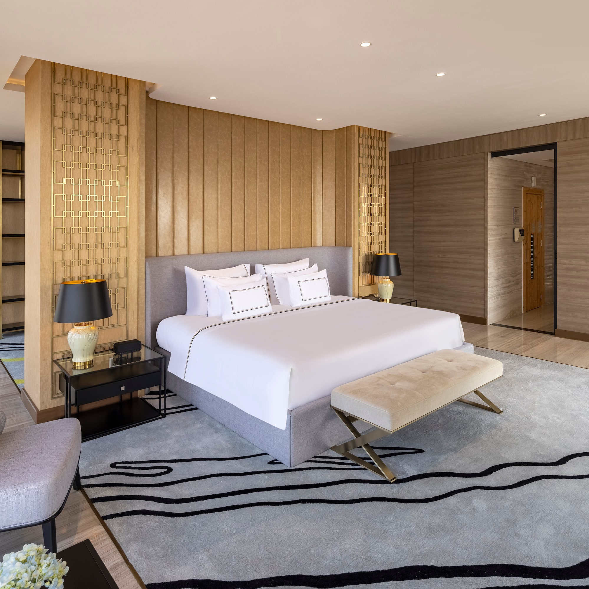 a bedroom with a bed and a rug