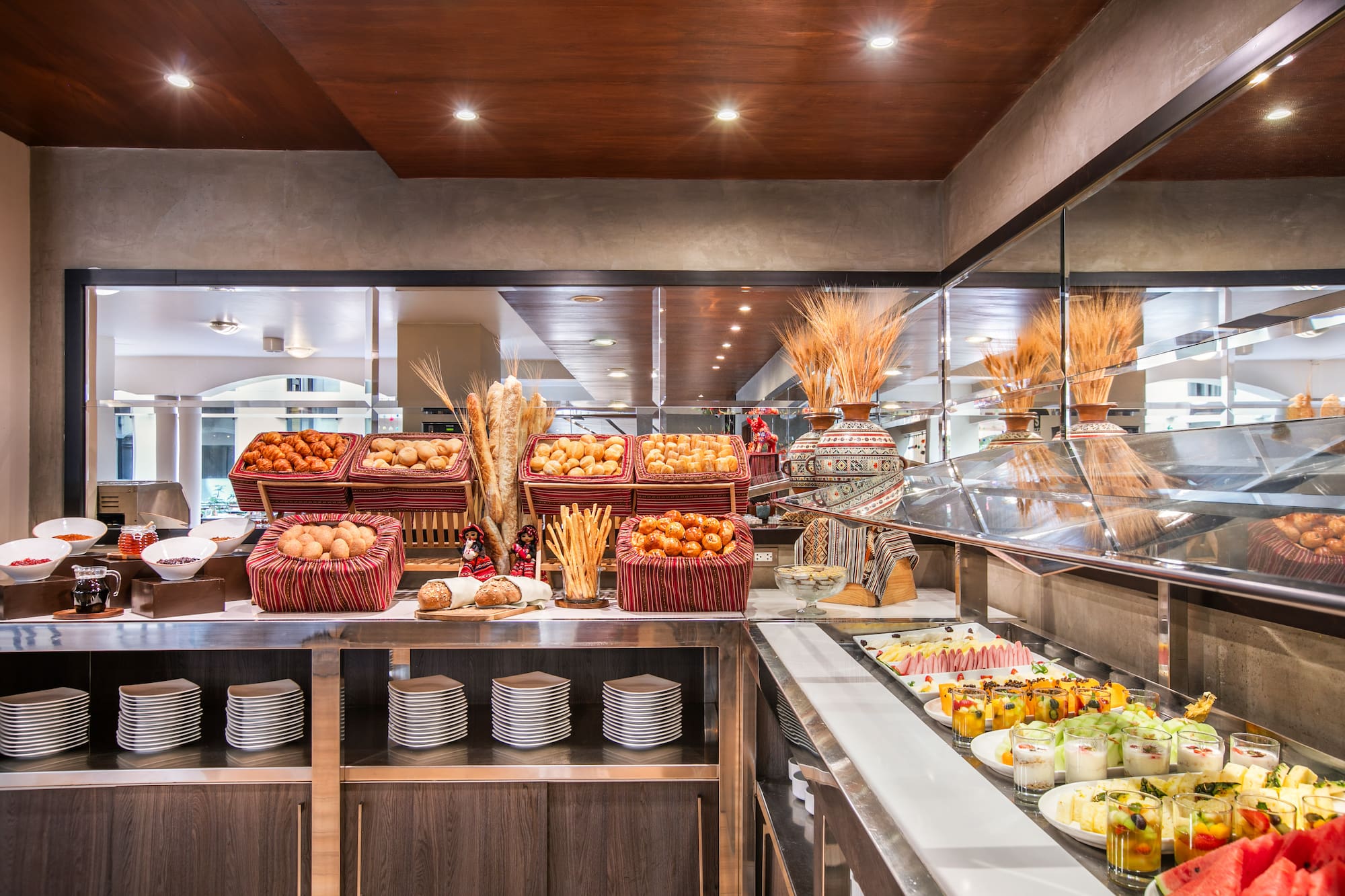 Hotel breakfast buffet with fresh bread, pastries, and fruit cups. - Hotel Cusco La Paccha Affiliated by Meliá, Cusco