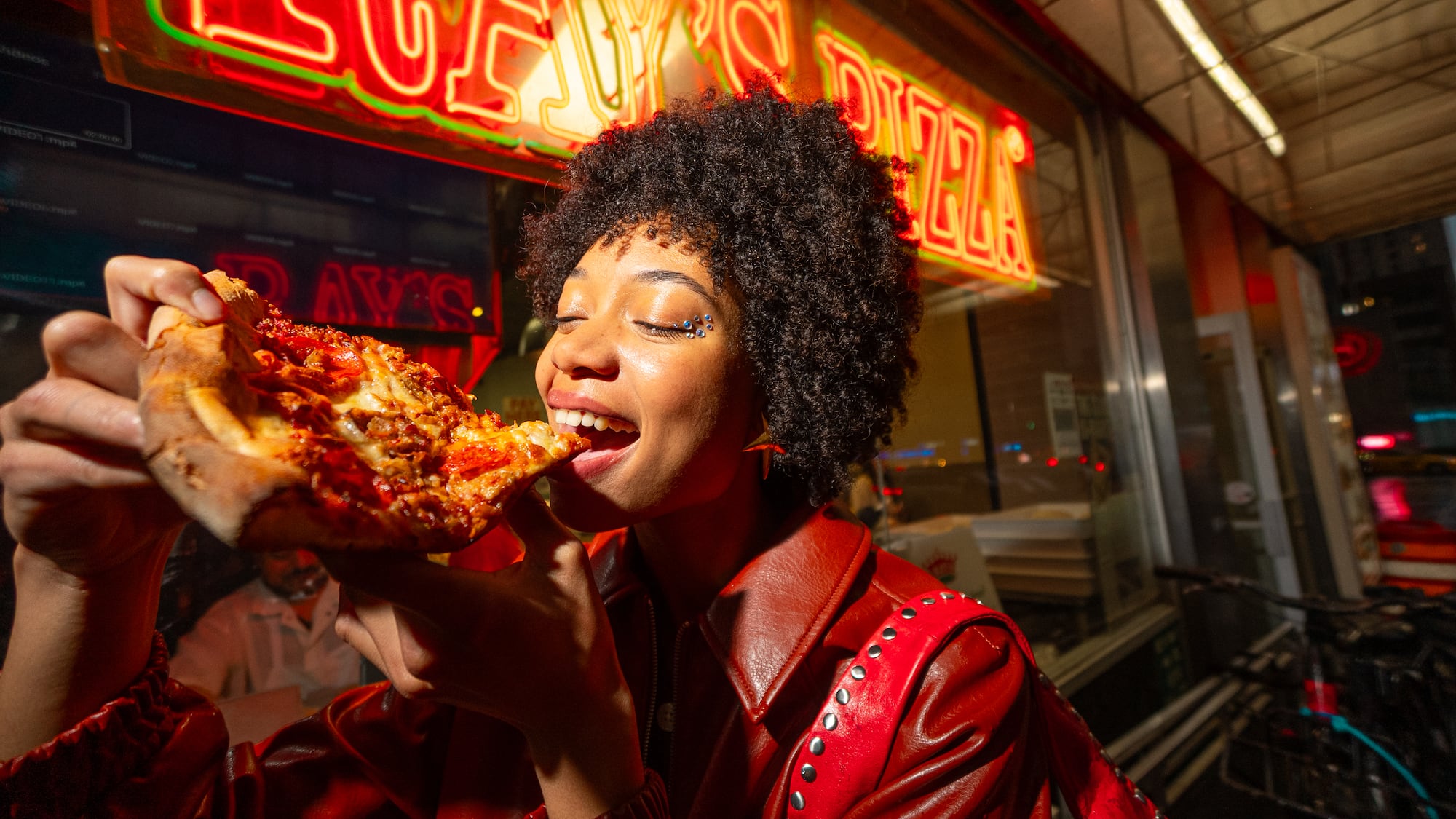 a woman eating a slice of pizza