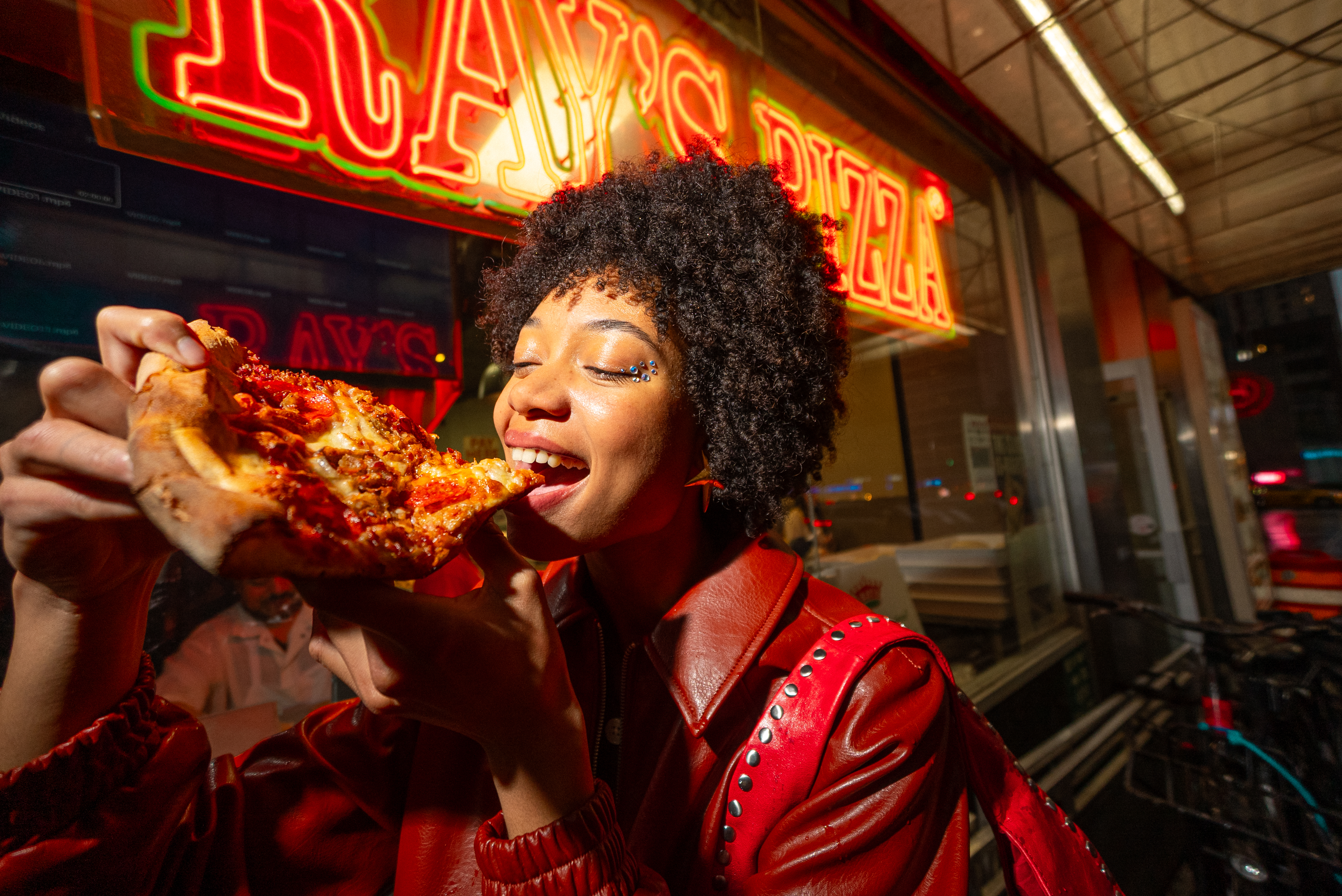 a woman eating a slice of pizza