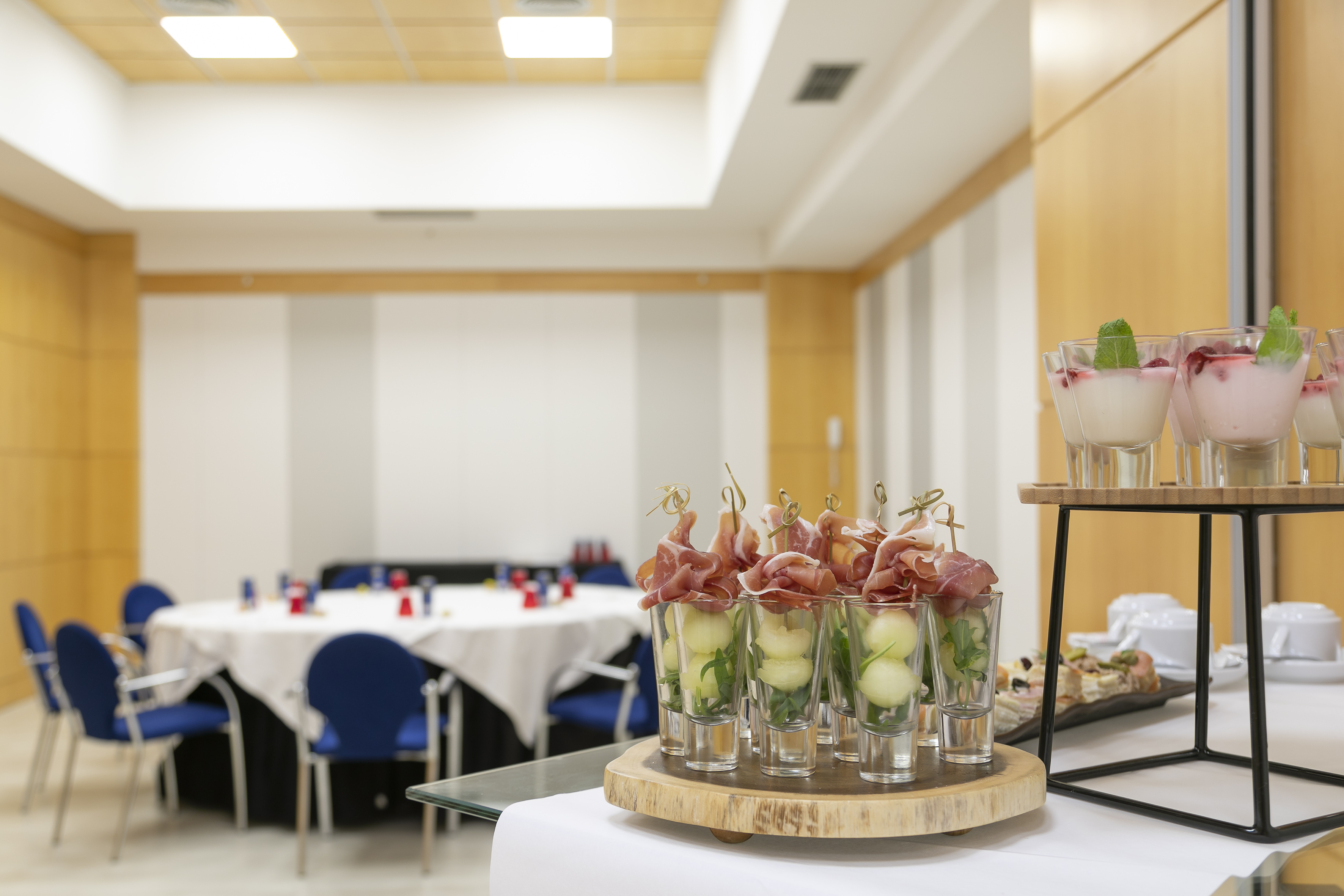 Conference catering: prosciutto melon appetizers, berry desserts.