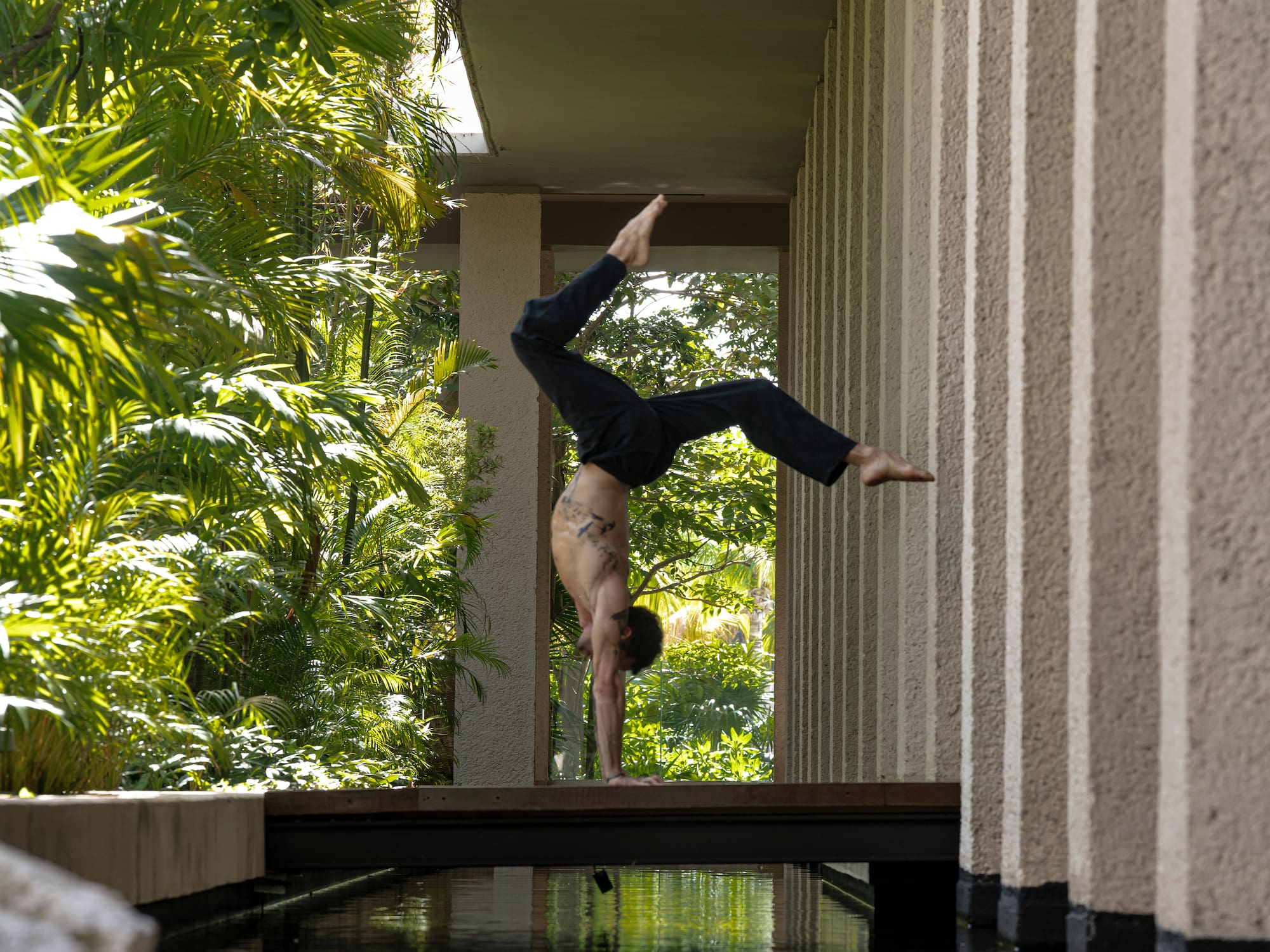 a man doing a handstand on a wall
