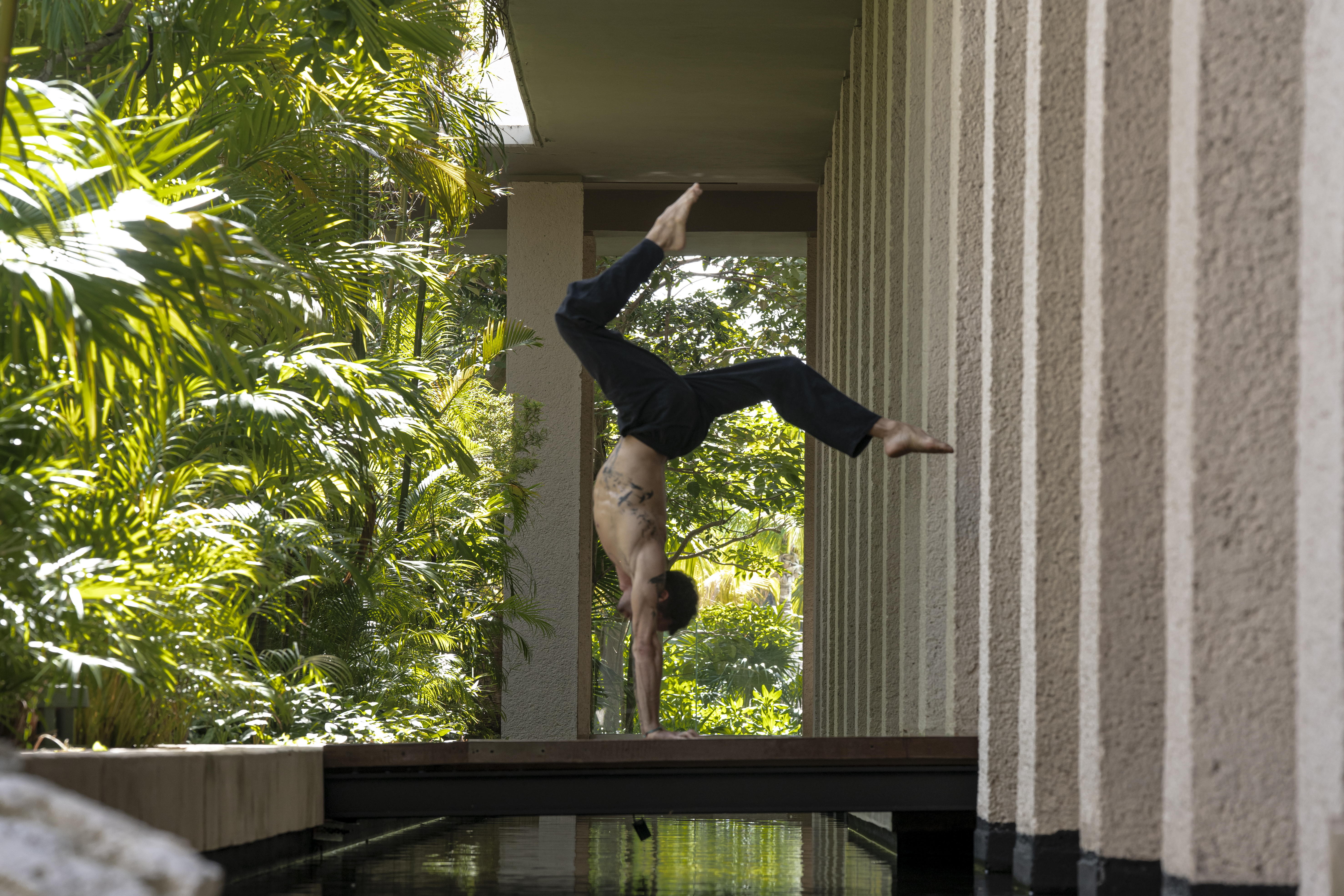 a man doing a handstand on a wall