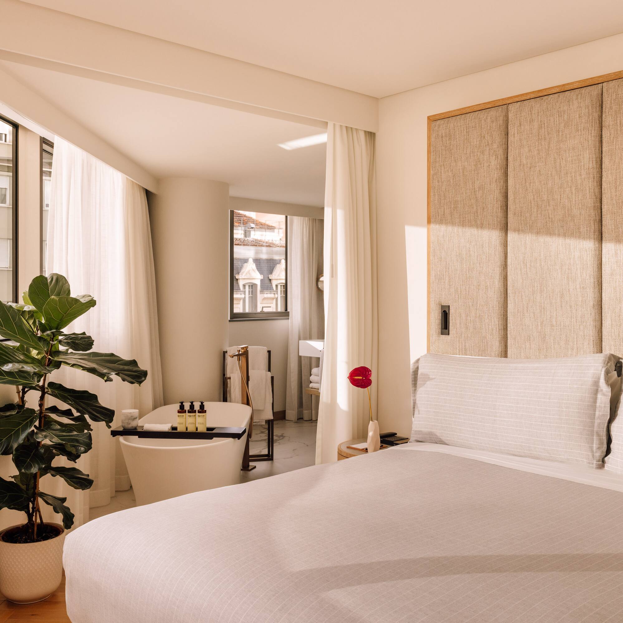 a bedroom with a bed and a plant