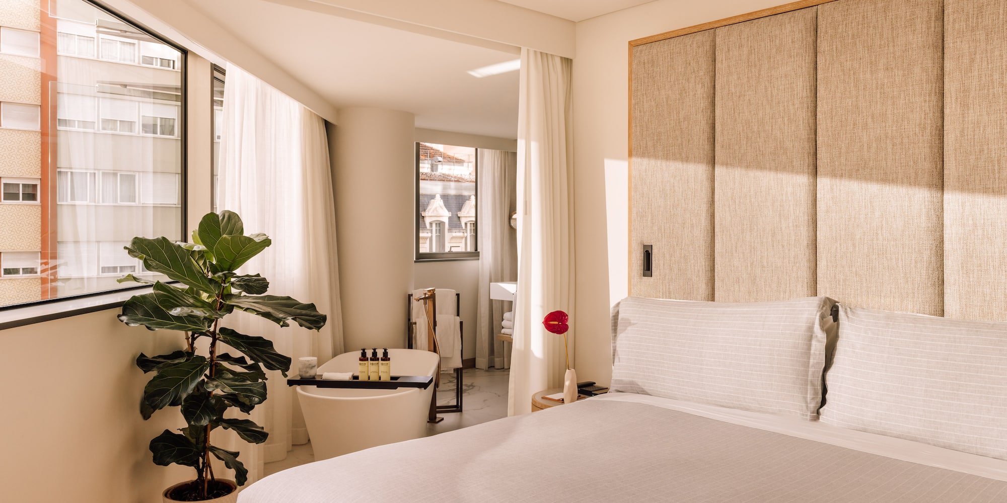 a bedroom with a bed and a plant