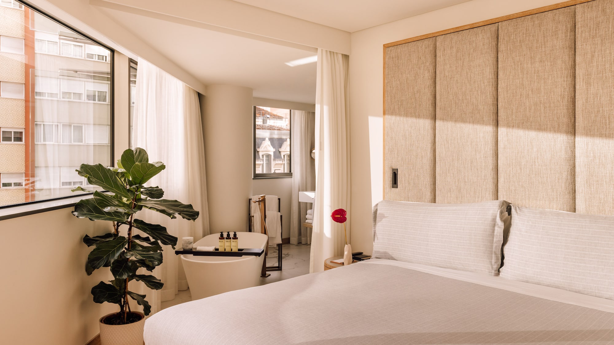 a bedroom with a bed and a plant