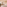 Modern hotel bedroom with freestanding tub, city view, and large fiddle leaf fig.