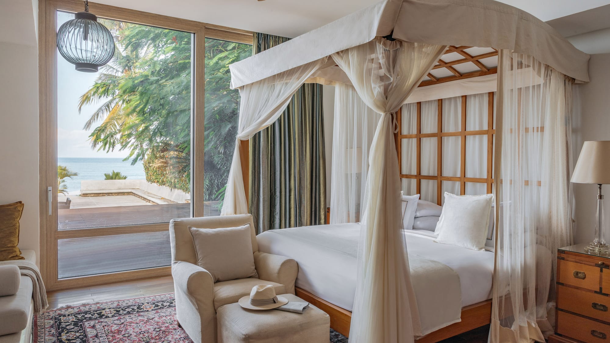 a bedroom with a canopy bed and a chair