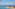 Luxury infinity pool with sun loungers, umbrellas, and ocean view.