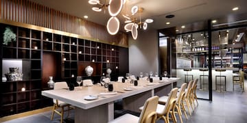 a large table with plates and chairs in a room