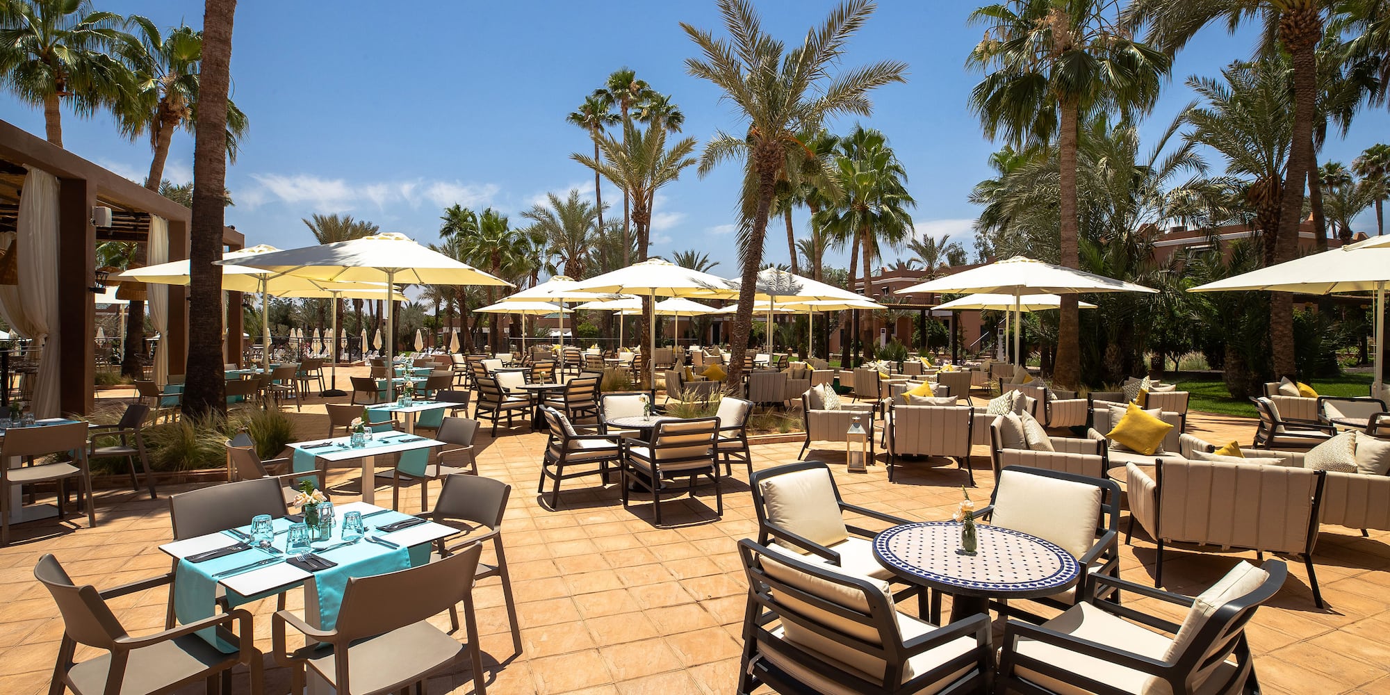 a patio with tables and chairs and umbrellas