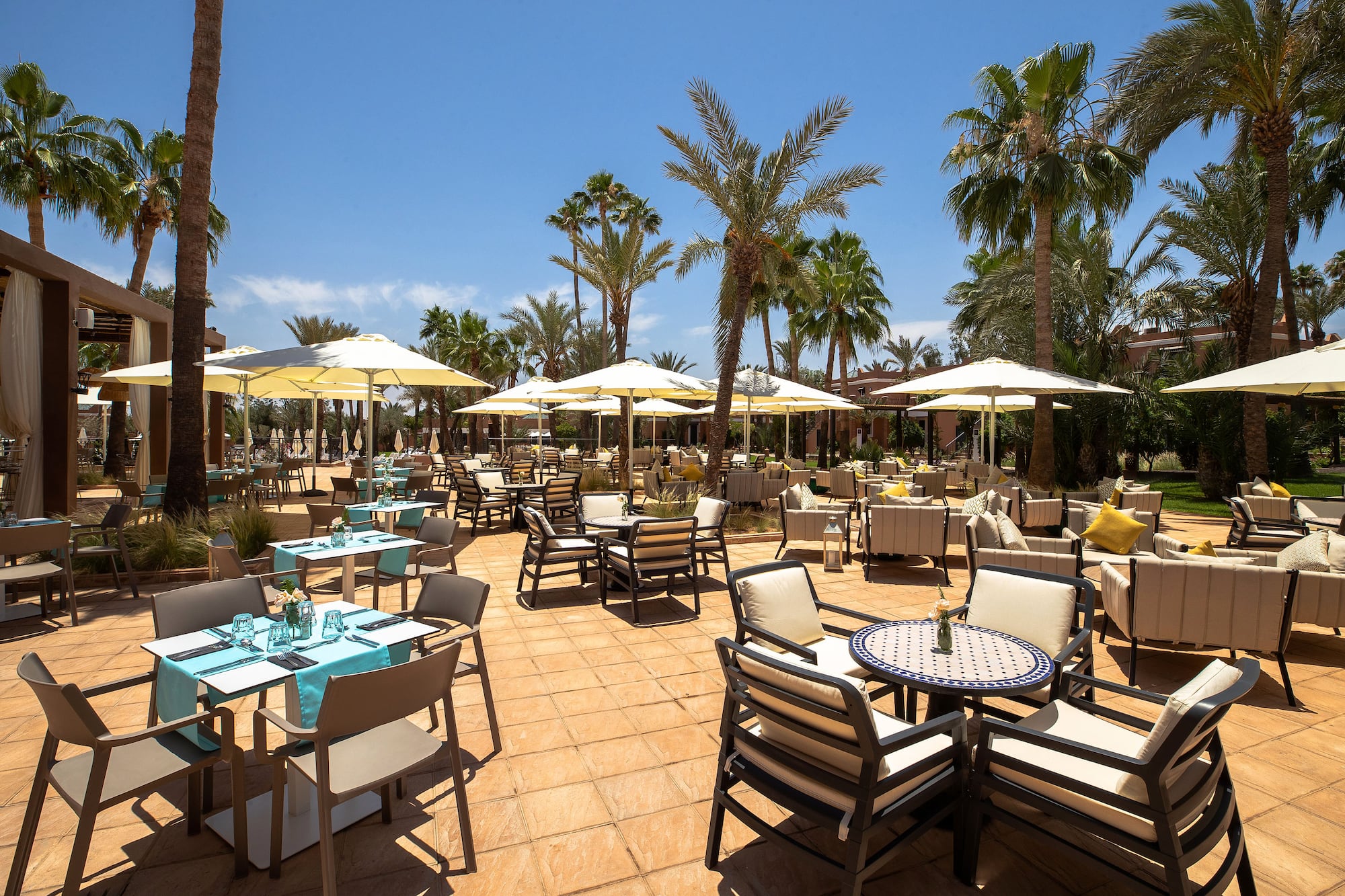a patio with tables and chairs and umbrellas