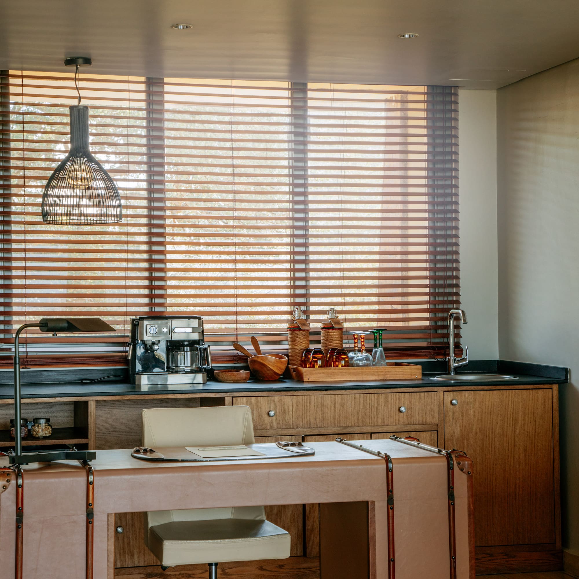 a kitchen with a table and a lamp