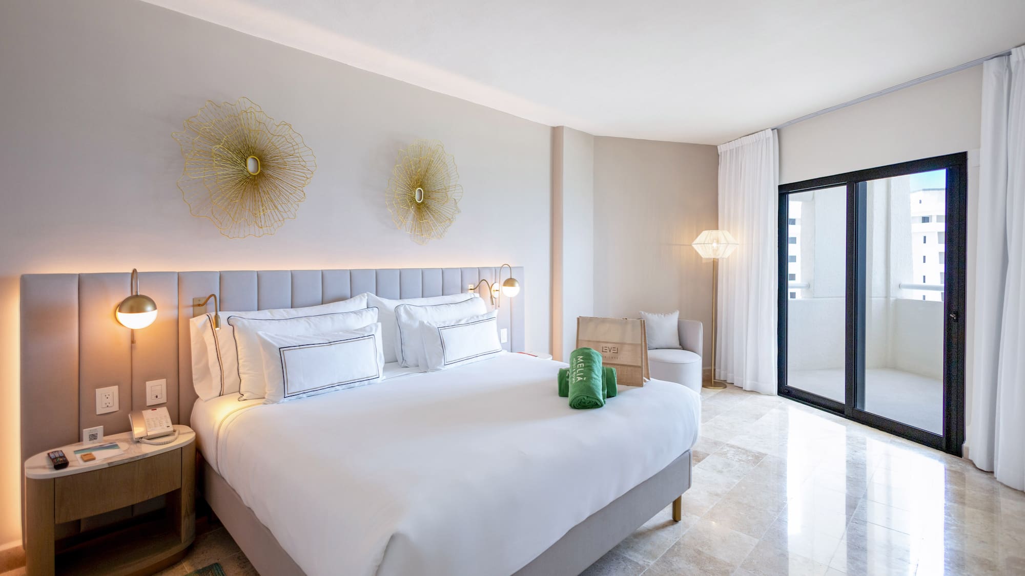 a bedroom with a bed and a glass door