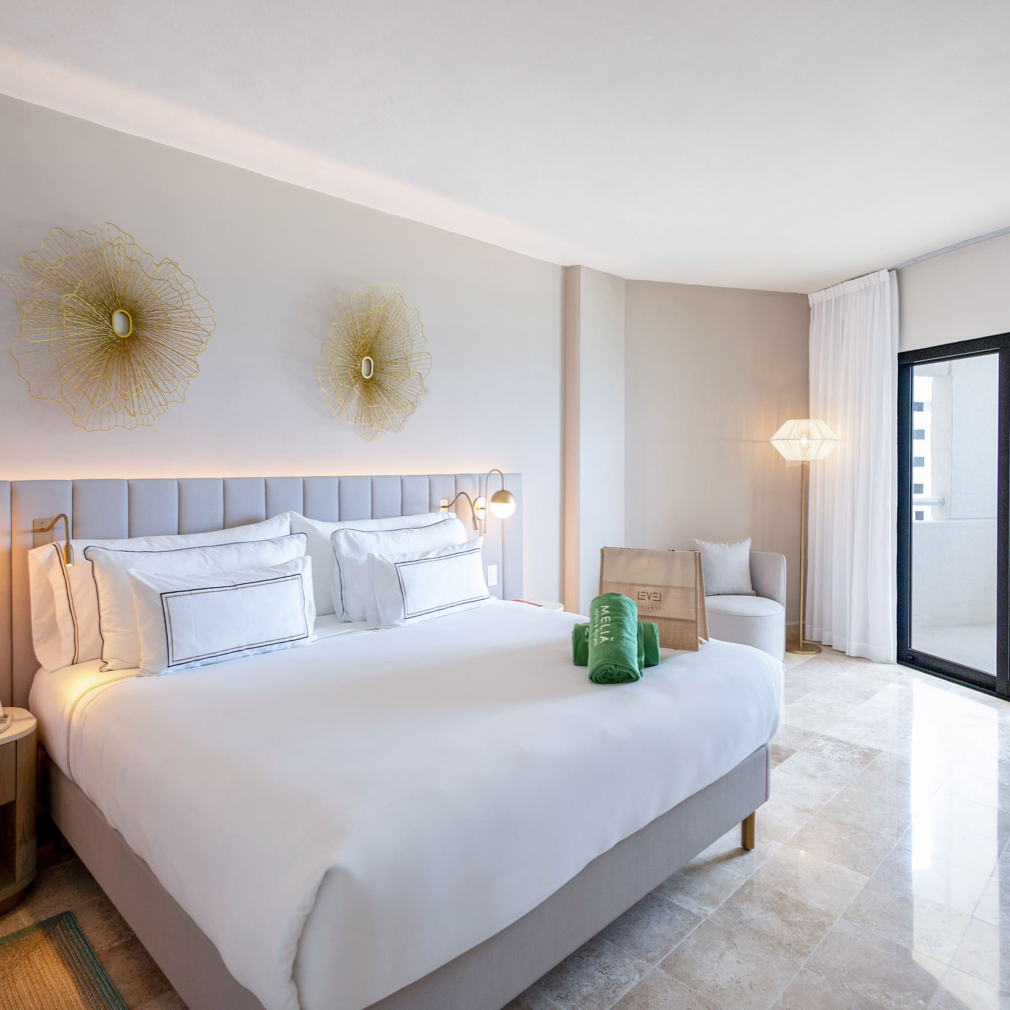 a bedroom with a bed and a glass door