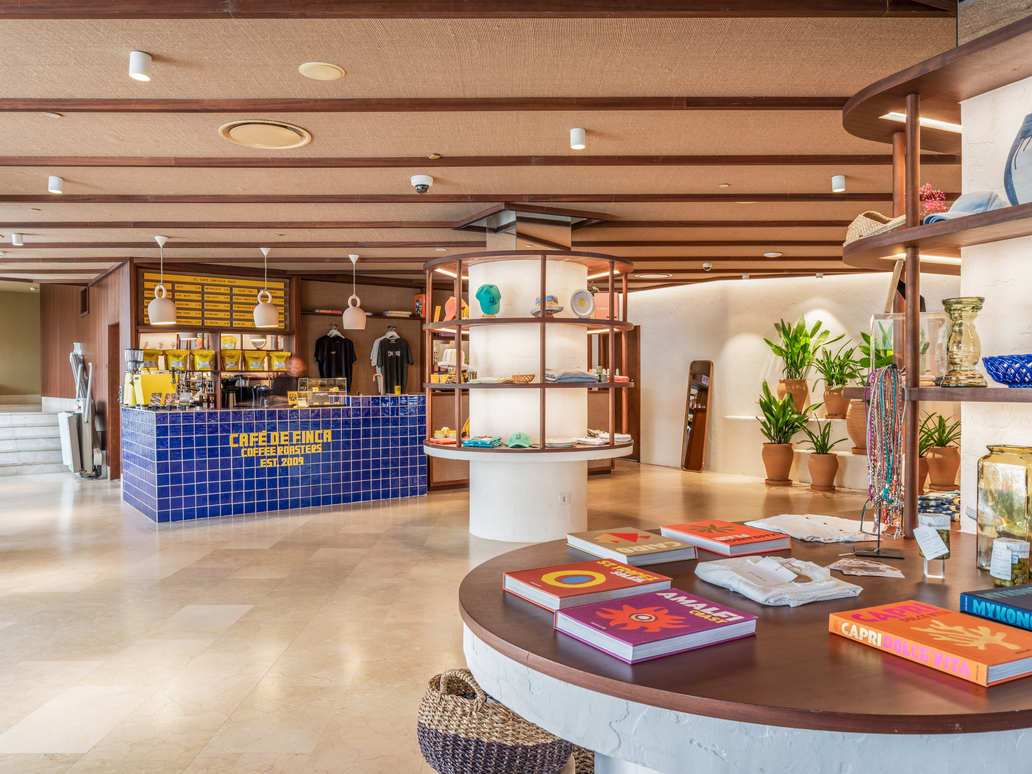 Cafe de Finca coffee shop and boutique with blue tiled counter and books.