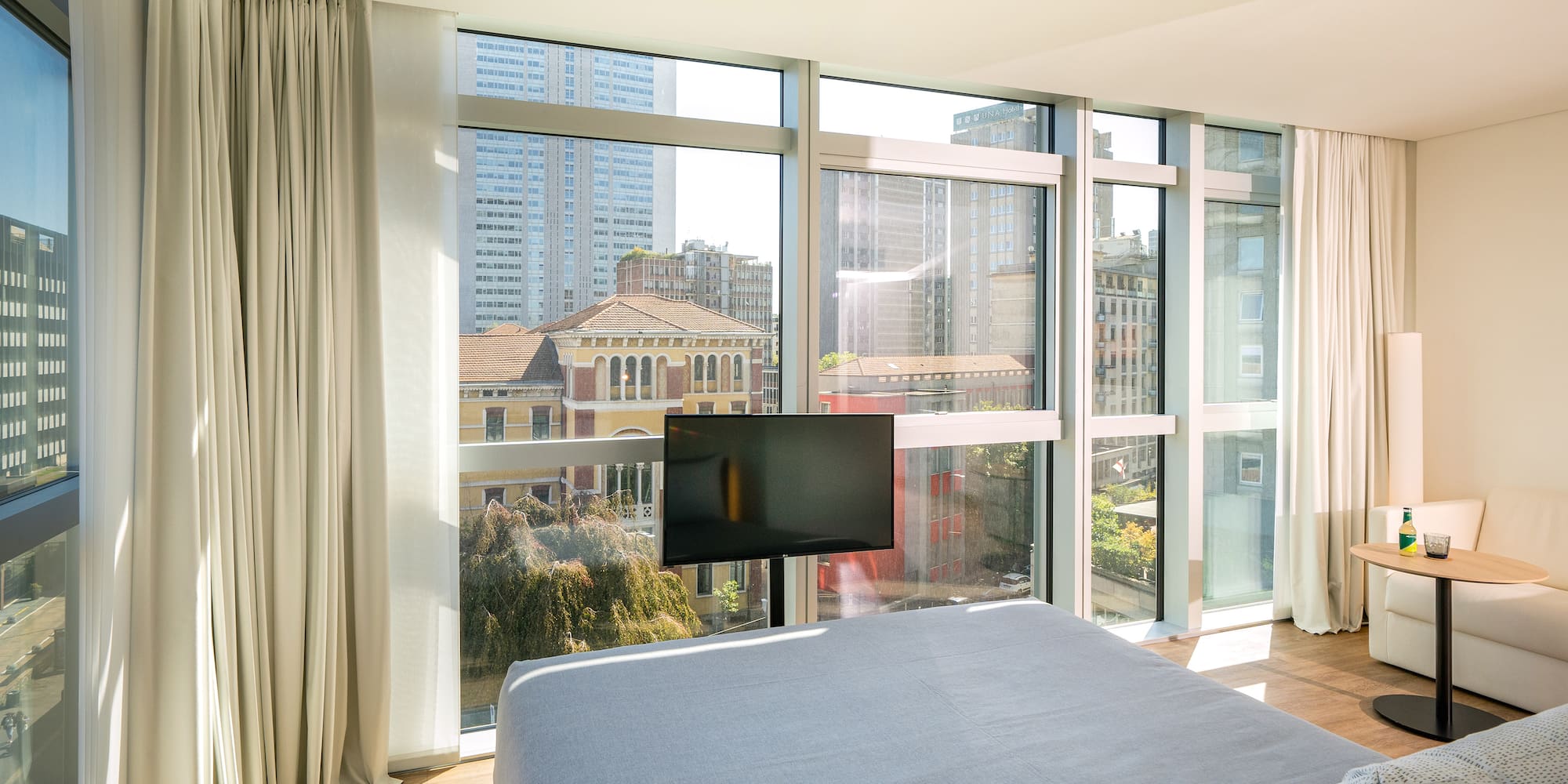 a bedroom with a television and a city view