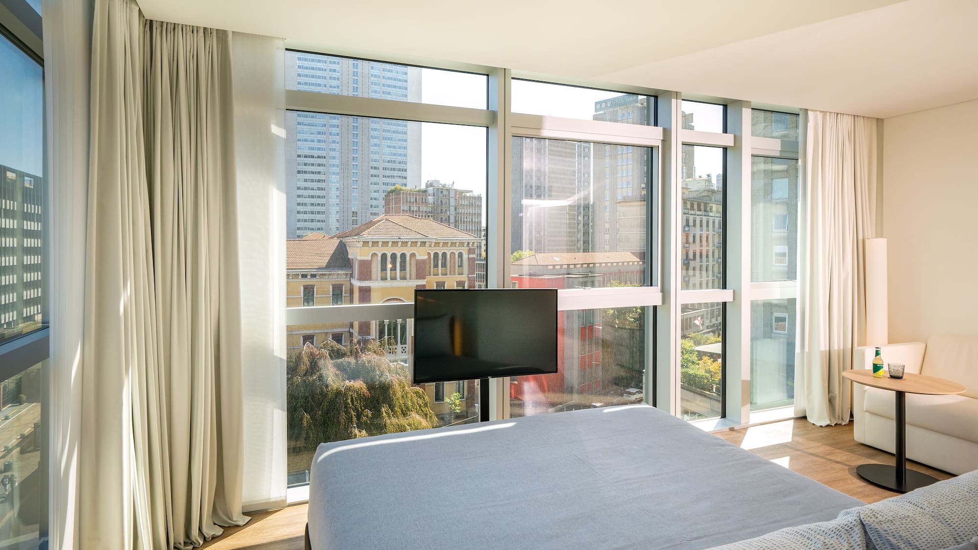 a bedroom with a television and a city view