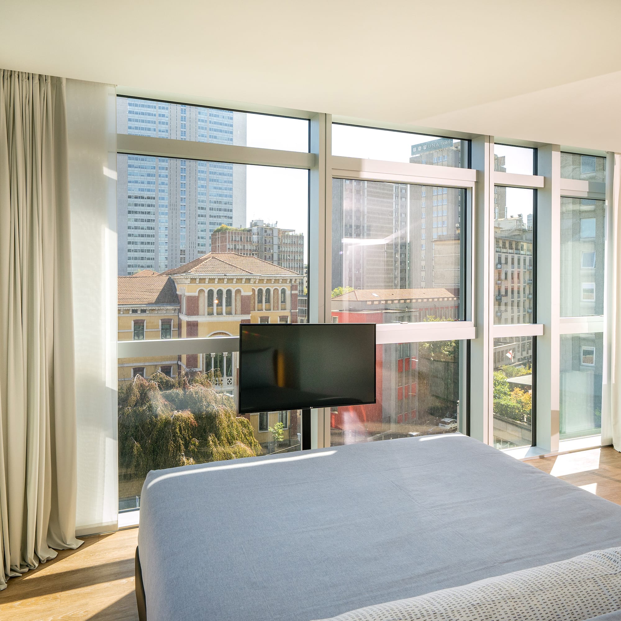 a bedroom with a television and a city view