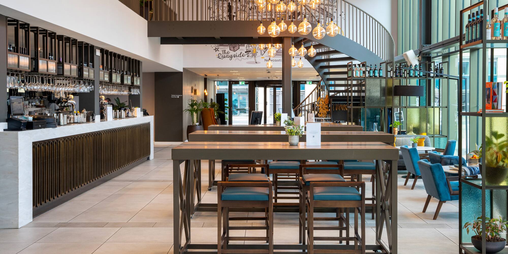 a room with a staircase and a table with chairs