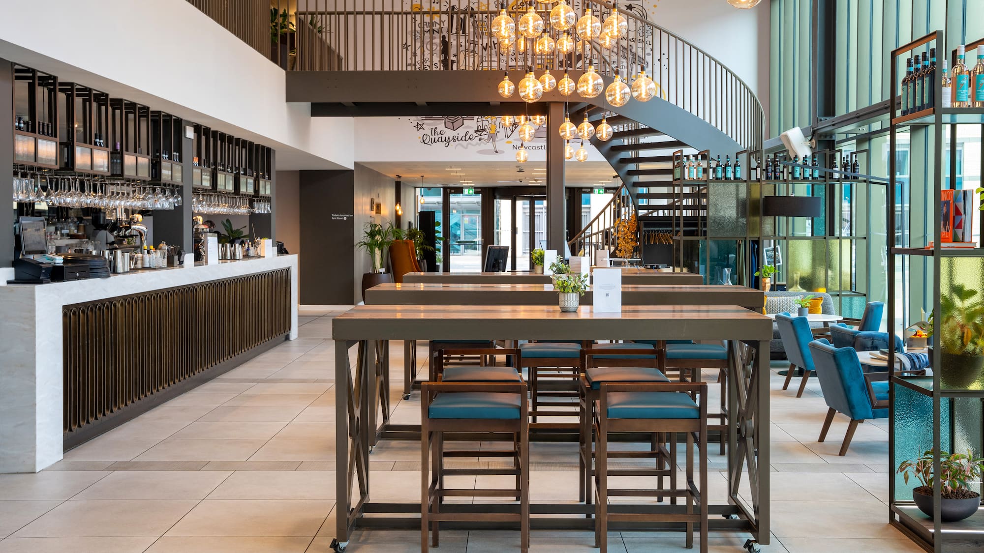 a room with a staircase and a table with chairs