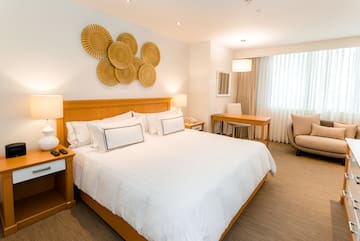 a bedroom with a bed and a chair