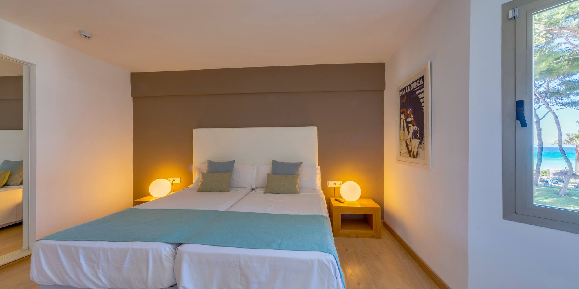 a bed with two pillows in a room