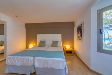 a bed with two pillows in a room