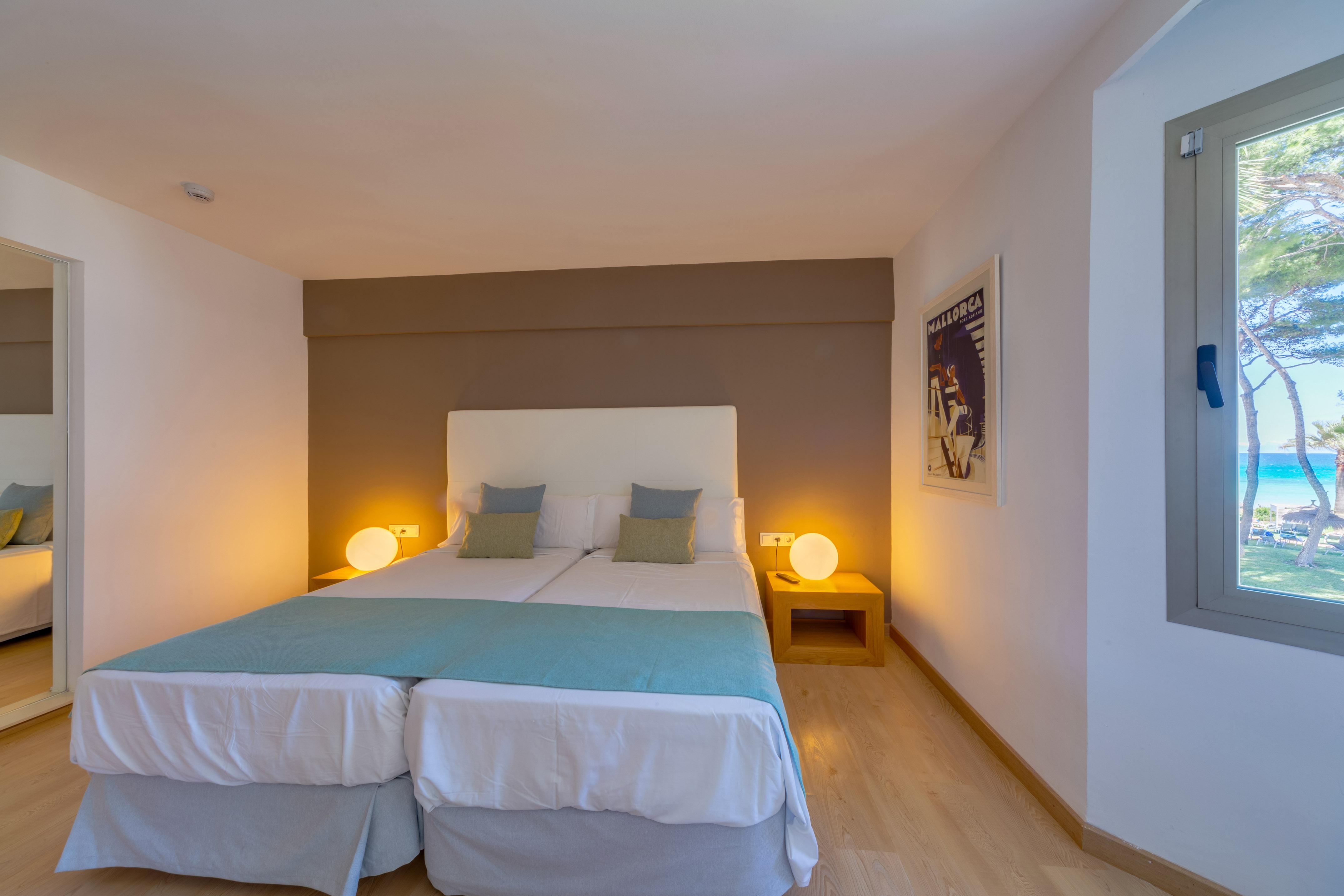 a bed with two pillows in a room