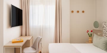 a room with a tv and a bed