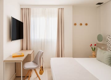 a room with a tv and a bed