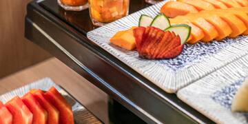 a tray of fruit and drinks