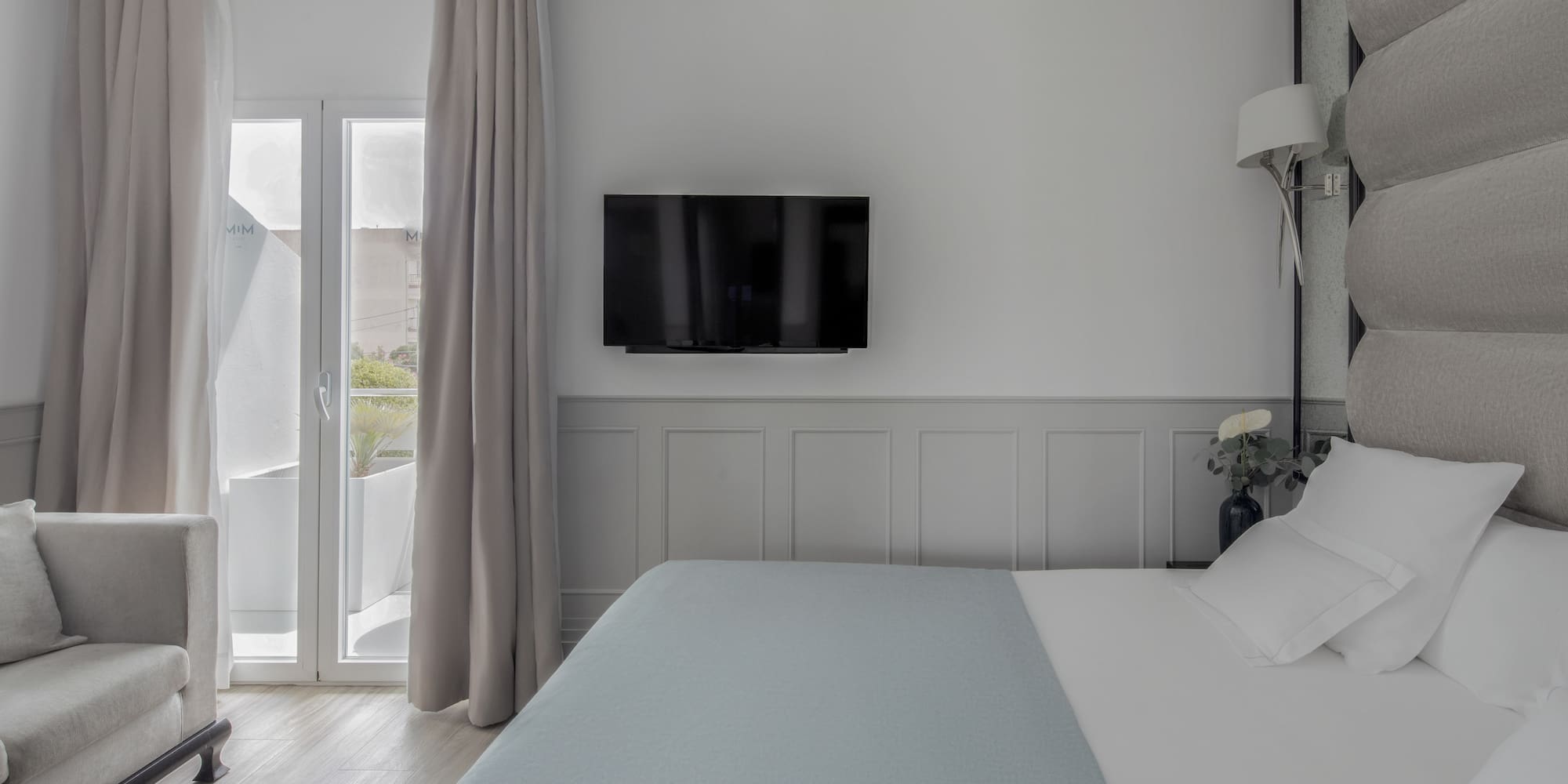 a bed with a flat screen tv in a room